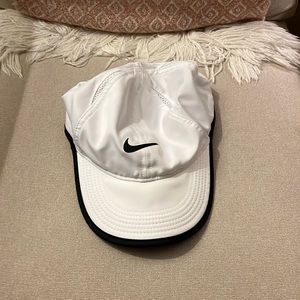 White Nike featherlight dri fit hat.